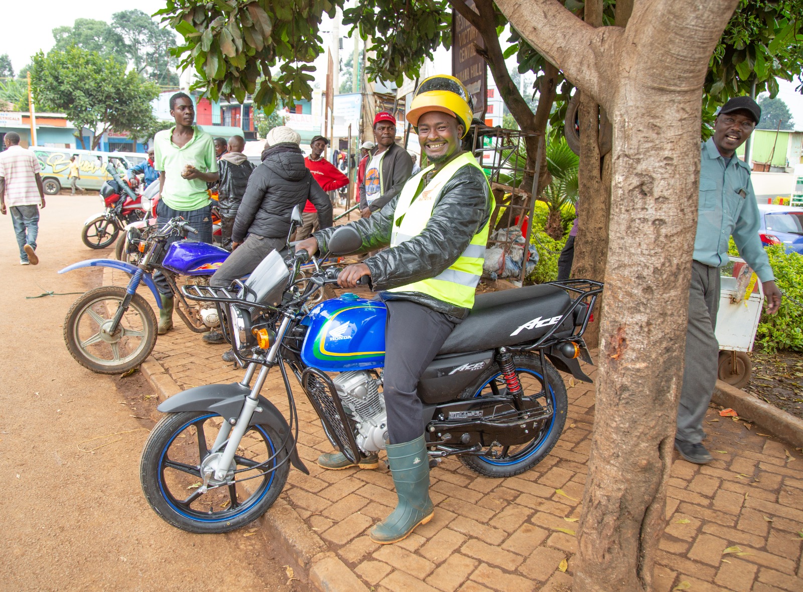 Wilson Kungu receives a motorbike from Pastor Dorcas Rigathi.